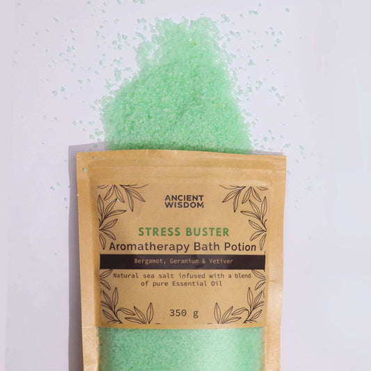 Aromatherapy Bath Potion Stress Buster with Bergamot, Geranium, and Vetiver in kraft bag with green bath salt spilling out