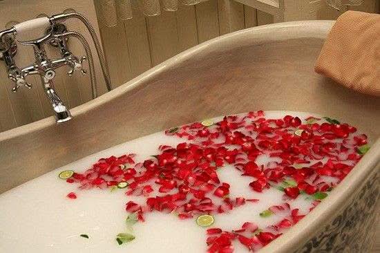 luxurious bath with soap flower box roses and rose petals in milky water