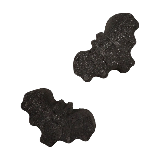 Bat Halloween bath bomb releasing dark colors in water