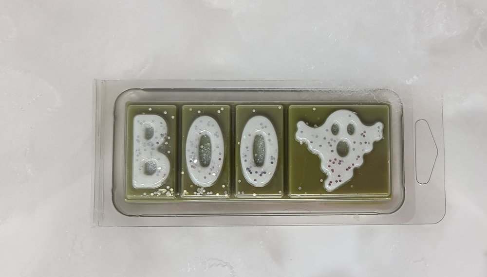 Boo Cinnamon Orange Wax Melt with ghost design in clamshell packaging, featuring spicy and citrus scents.