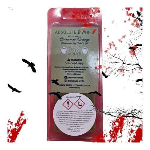 Halloween-themed wax melt with cinnamon, orange, and vanilla scents in clamshell packaging.