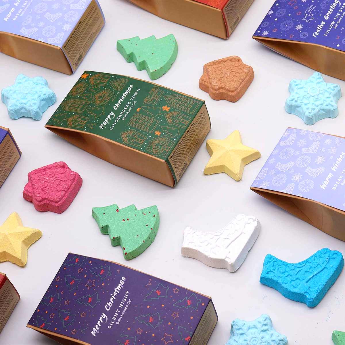 Break the Ice Christmas Bath Bomb Gift Pack with assorted colorful festive shaped bath bombs including stars, trees, snowflakes, and stockings