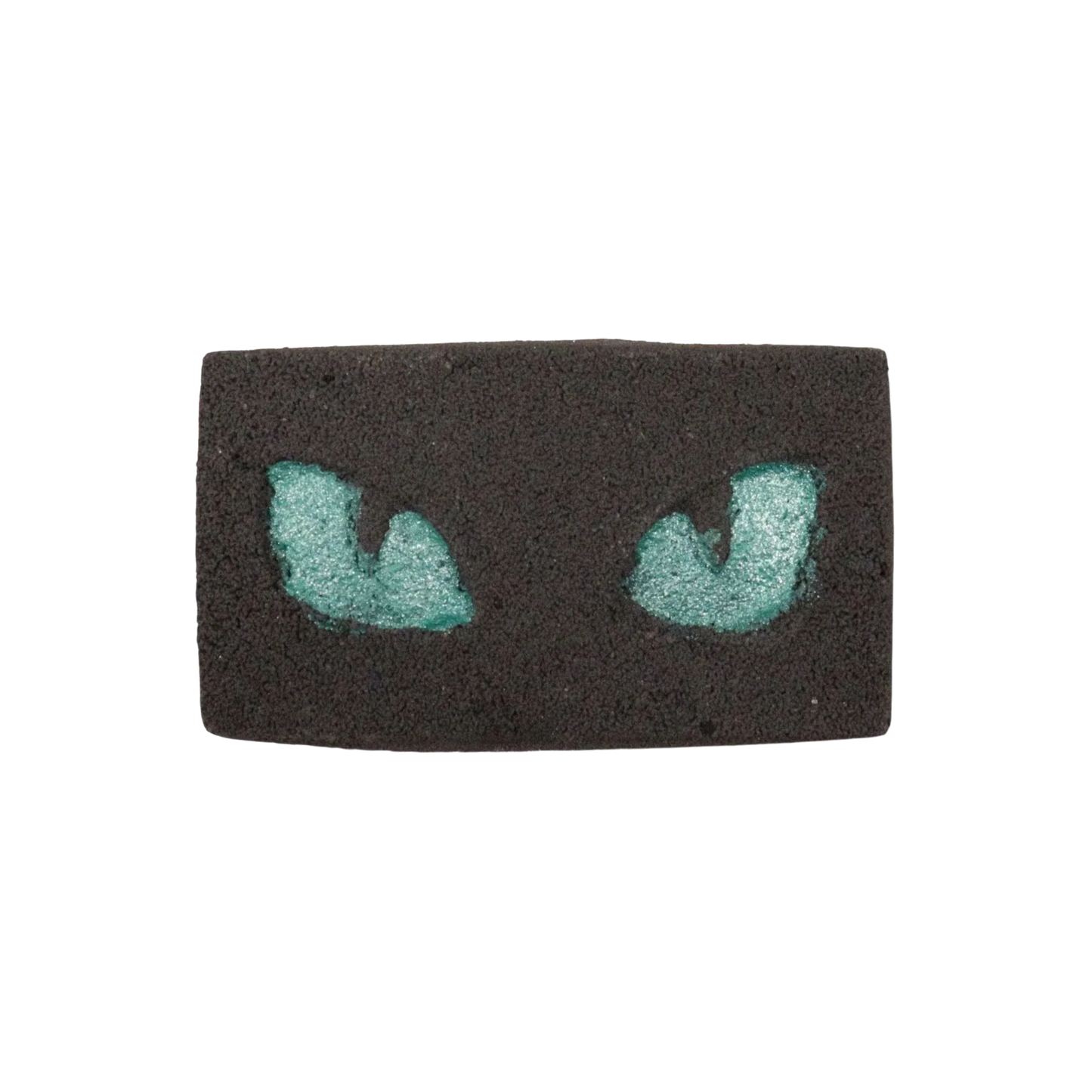 Cats Eyes Halloween Bath Bomb with glowing teal cat eyes in black base