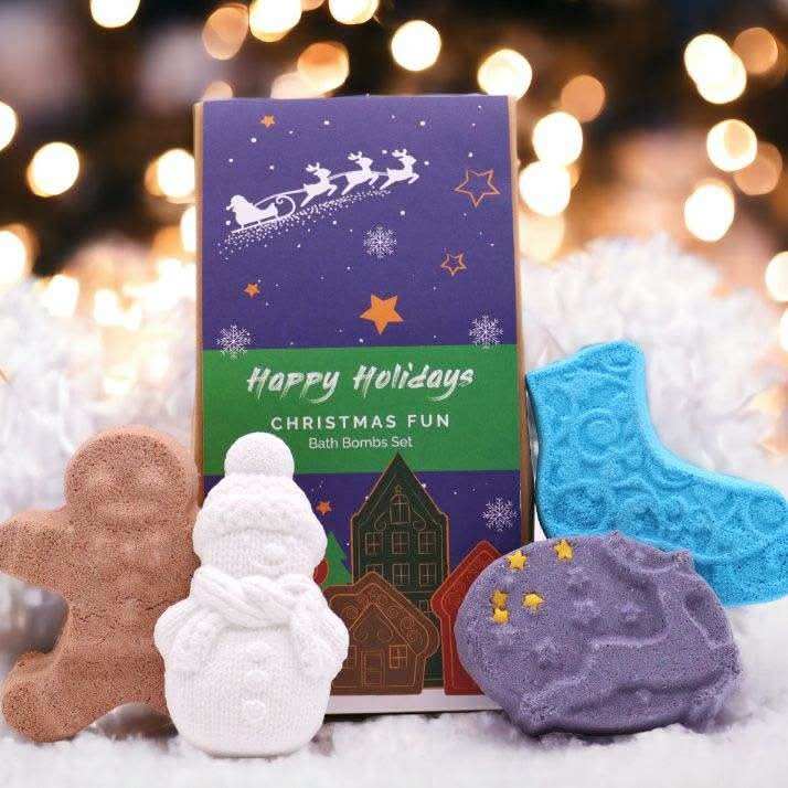 Christmas Fun Bath Bomb Gift Pack featuring festive shaped bath bombs in white, brown, blue, and purple with holiday designs