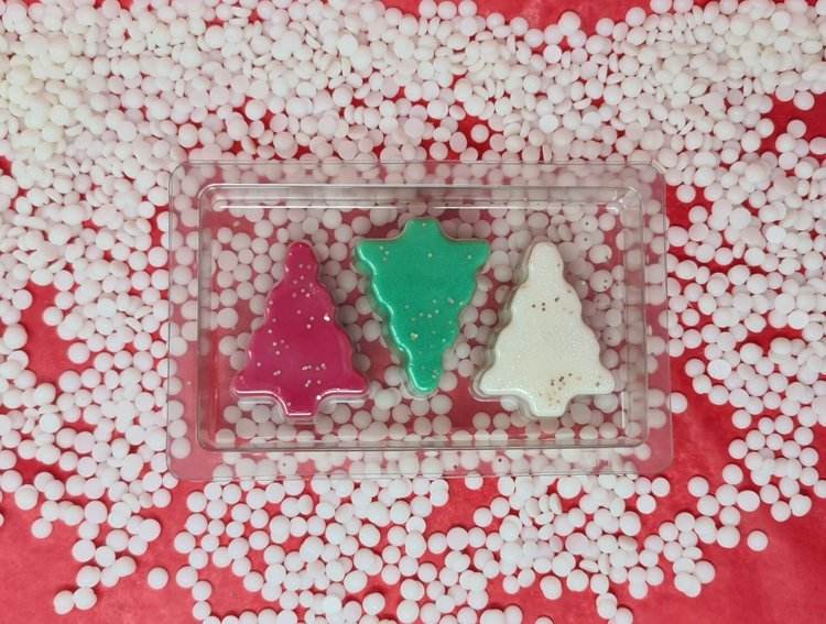 Christmas Tree Scented Wax Melts in vibrant colors on decorative background.