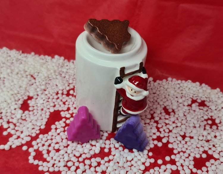 Christmas tree scented wax melts in vibrant colors with Santa-themed holder.