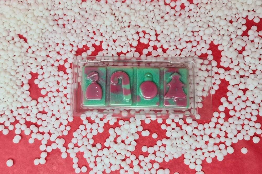 Cranberry Peppermint wax melt snap bar with festive shapes on a red and white background.