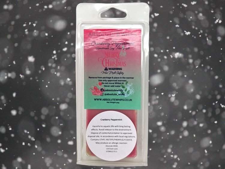 Cranberry Peppermint Wax Melt Snap Bar in festive packaging with snowy background.