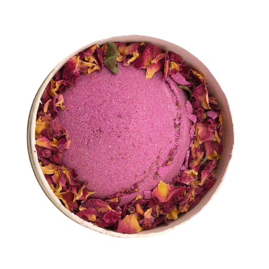 Cupids Self Care Aromatherapy Bath Collection pink bath bomb with textured surface and dried rose petals