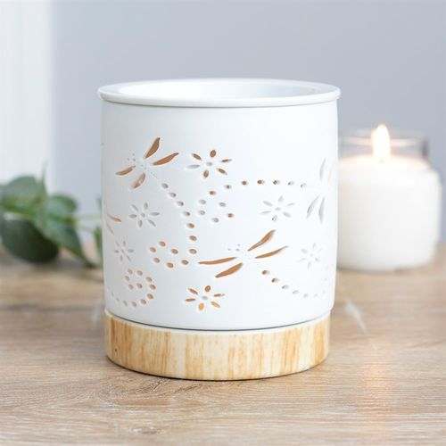 Dragonfly matte ceramic oil burner with intricate design and wooden base.