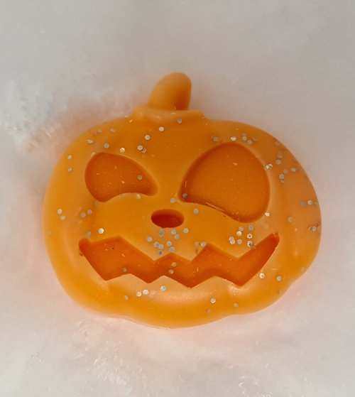 Large pumpkin-shaped wax melt with glitter, scented with pumpkin spice for Halloween.