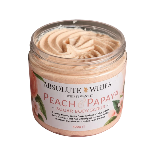 Peach and Papaya Sugar Body Scrub in a clear jar, showing peach-coloured whipped scrub with a floral fruit label