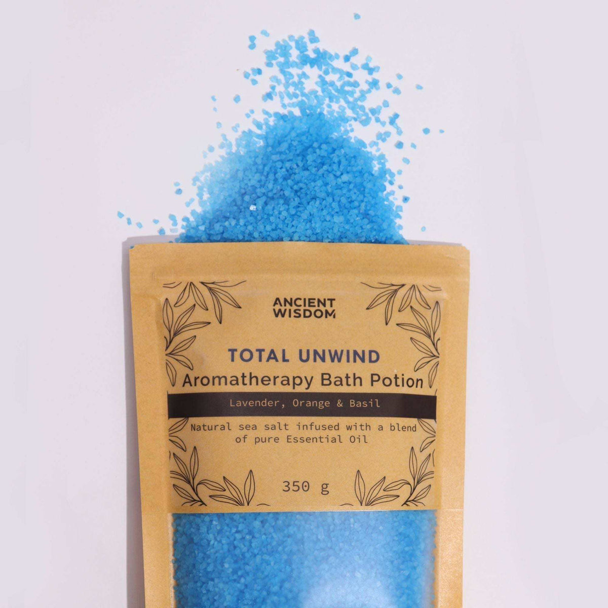 Brown total unwind pouch with blue aromatherapy bath salts spilling out