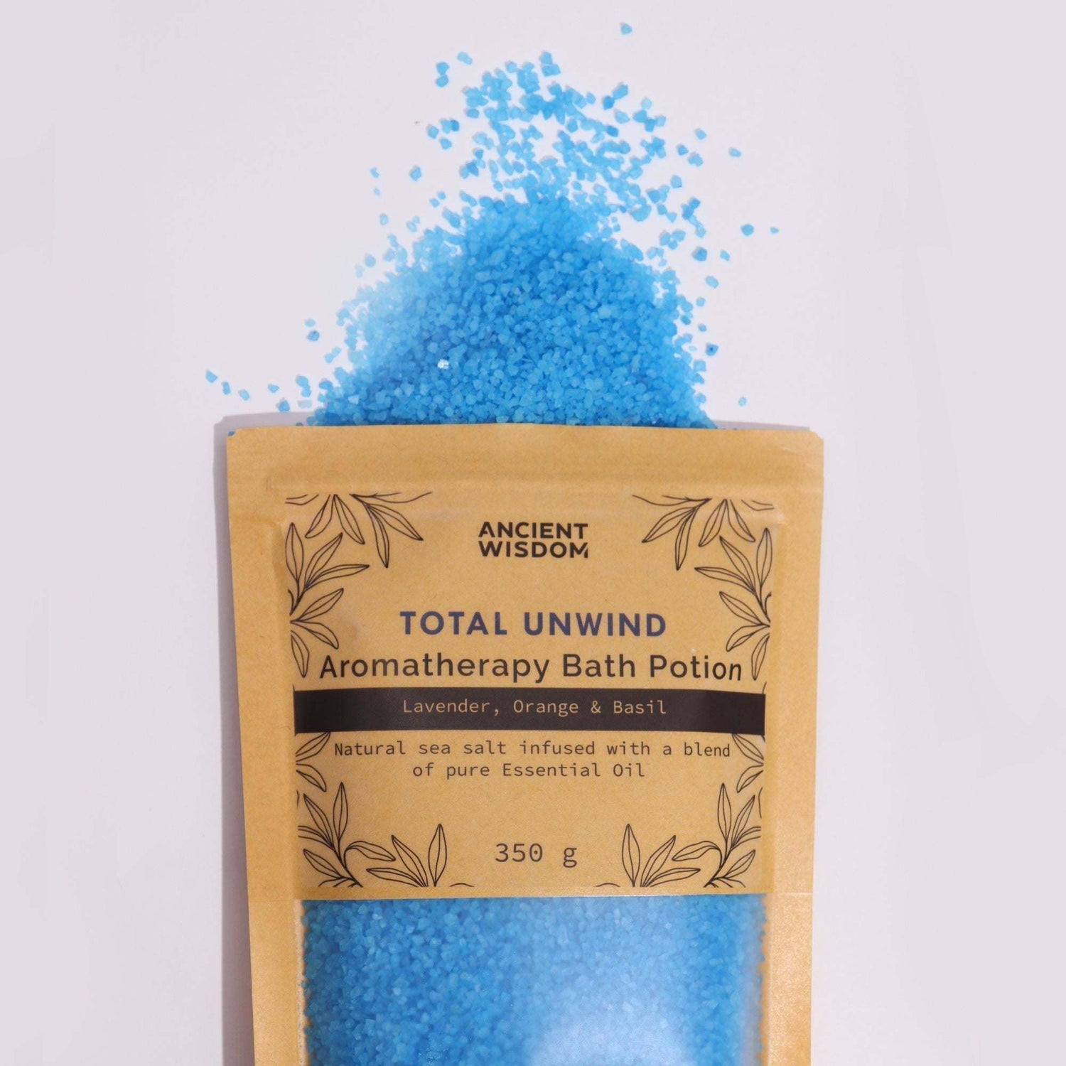 Brown total unwind pouch with blue aromatherapy bath potion salts spilling out