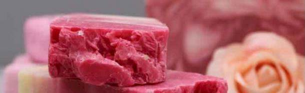 Red soap bar with soap flowers in the background