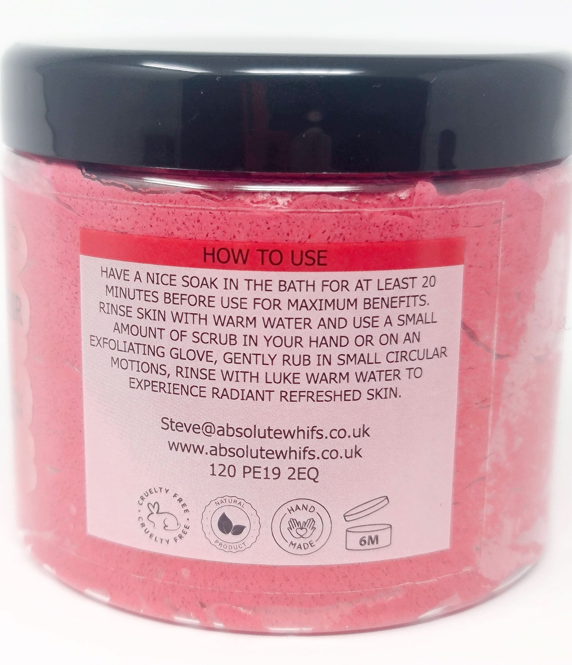 Pomegranate Noir Sugar Body Scrub in clear jar with black lid showing usage instructions and pink texture