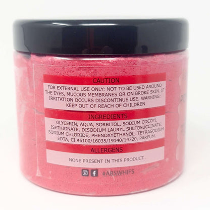 Pomegranate Noir Sugar Body Scrub in pink jar with black lid showing ingredients and caution label