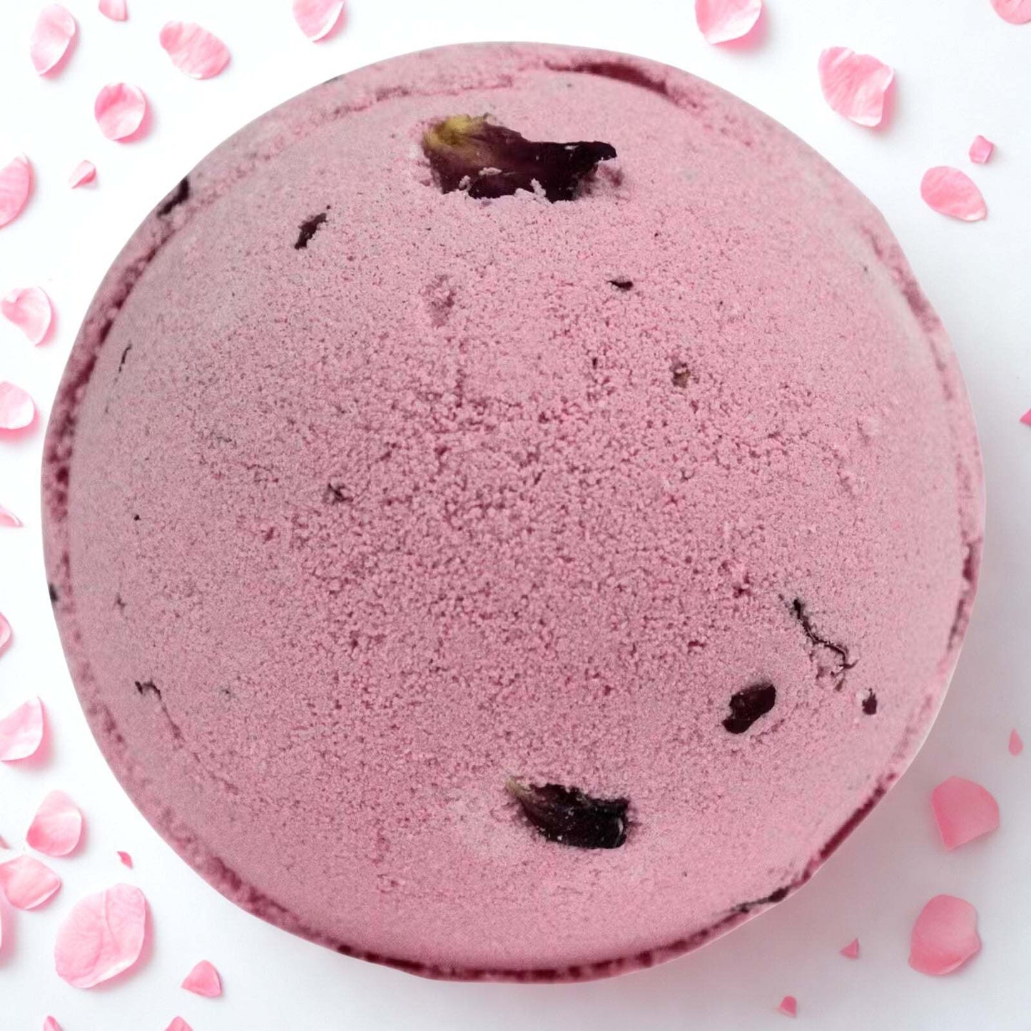 Pink Rose & Petals Bath Bomb surrounded by rose petals for luxurious fragrant bath soak