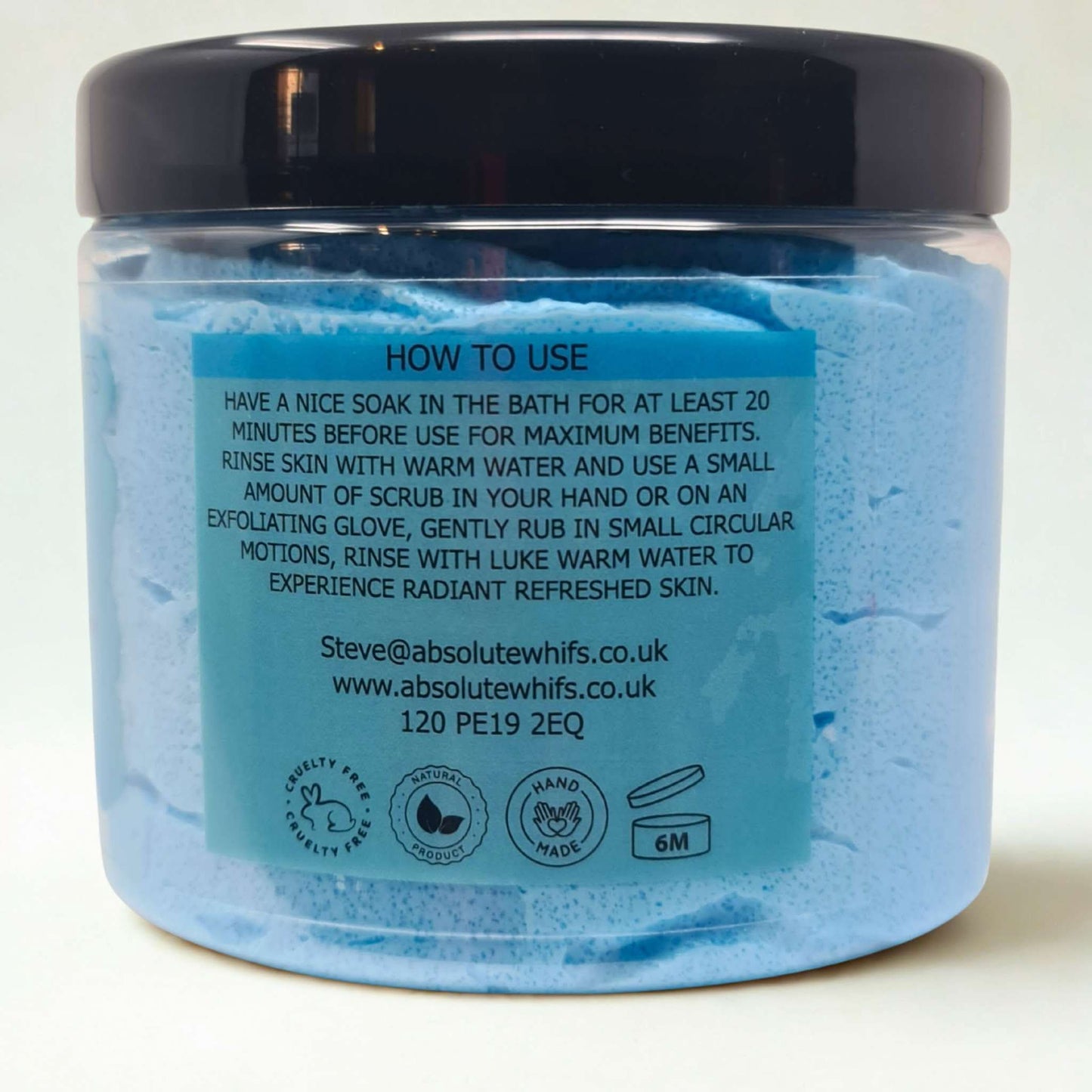 Sea Breeze Sugar Body Scrub in a clear jar with black lid showing blue exfoliating scrub and usage instructions label