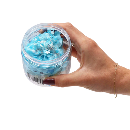 Absolute Whifs blue whipped soap in a clear jar with snowflake sprinkles held in a hand against a white background