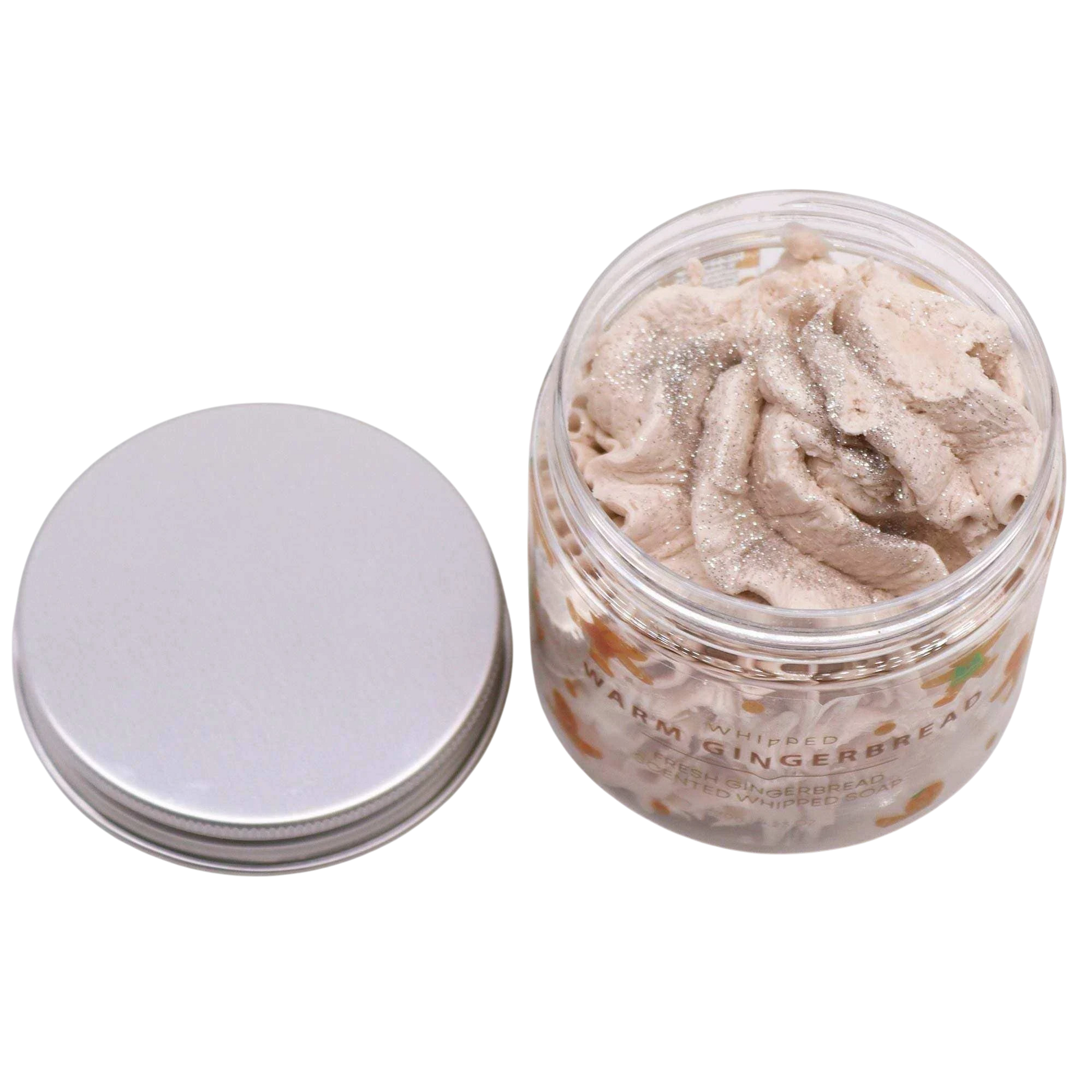 Absolute Whifs Warm Gingerbread whipped soap in a clear jar with a silver lid, featuring a light beige creamy texture.