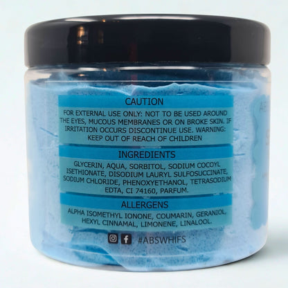 Sea Breeze Sugar Body Scrub jar with blue sugar exfoliant and black lid showing caution, ingredients, and allergens labels