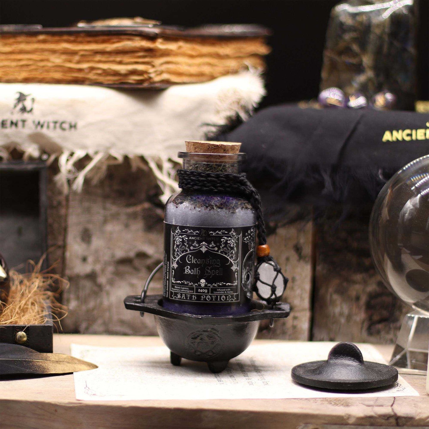 Ancient witch bath spell potion in glass bottle with cork and rock crystal amulet on black cord