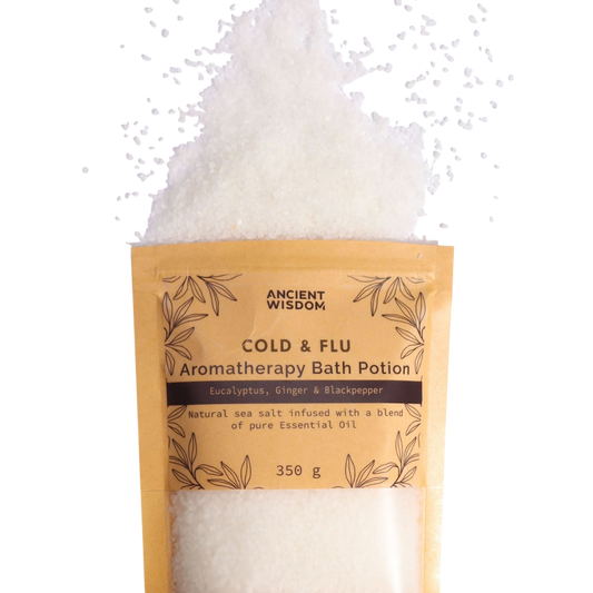 Aromatherapy Bath Potion - Colds & Flu in a kraft paper bag with white mineral-rich sea salt spilled above, featuring eucalyptus, ginger, and black pepper essential oils