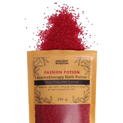Aromatherapy Bath Potion - Passion in a kraft paper bag with red bath salt crystals spilling out, featuring ylang-ylang, lemon, and orange oils