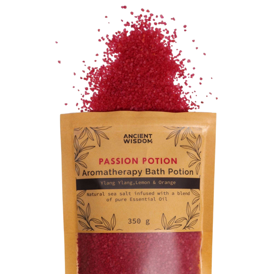 Aromatherapy Bath Potion - Passion in a kraft paper bag with red bath salt crystals spilling out, featuring ylang-ylang, lemon, and orange oils