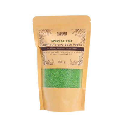 Aromatherapy Bath Potion - PMT in a kraft paper bag with green sea salt crystals and essential oil blend label