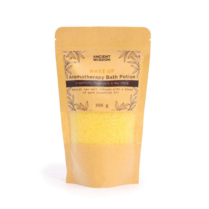 Aromatherapy Bath Potion - Wake Up in a kraft paper bag with yellow mineral-rich sea salt inside and essential oil blend label
