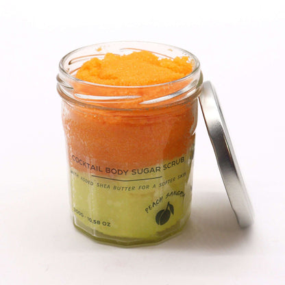 Fragranced sugar body scrub in a jar with peach sangria scent and orange and green layers