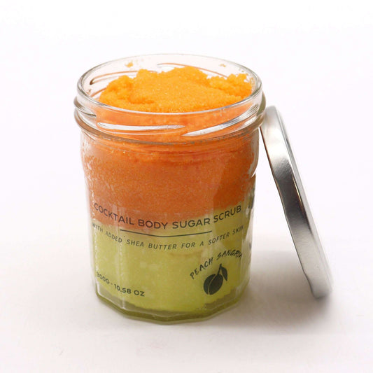 Fragranced sugar body scrub in a jar with peach sangria scent and orange and green layers