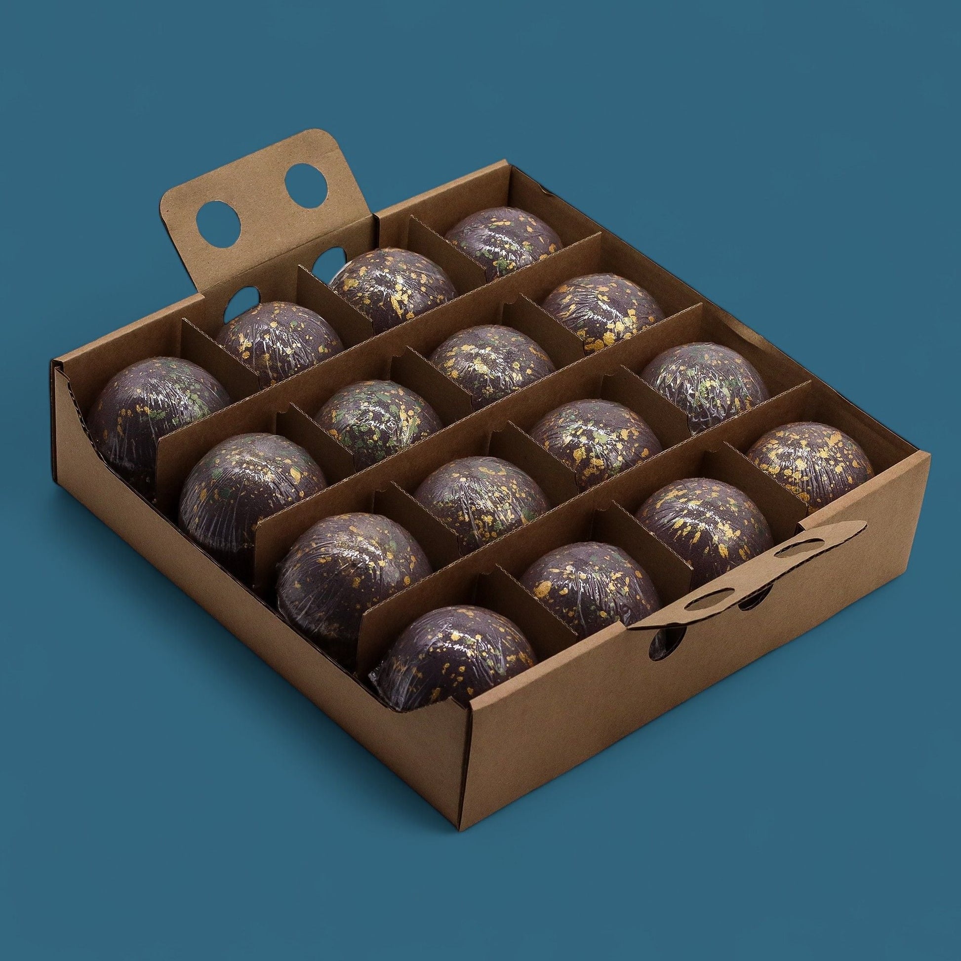 Dubai Bath Bomb Emerald Oudh Truffle set arranged in eco-friendly box with gold speckles on dark purple bombs