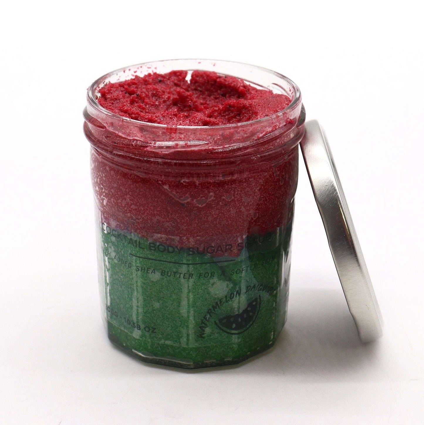 Fragranced sugar body scrub in watermelon daquiri scent with red and green layers in a 300g jar