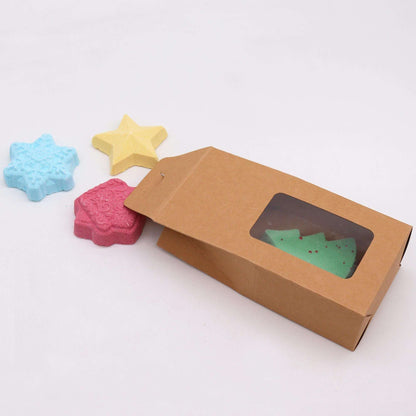 Christmas Bath Bomb Gift Pack with snowflake, star, Christmas tree, and gingerbread house shaped bath bombs in festive colors and eco-friendly packaging