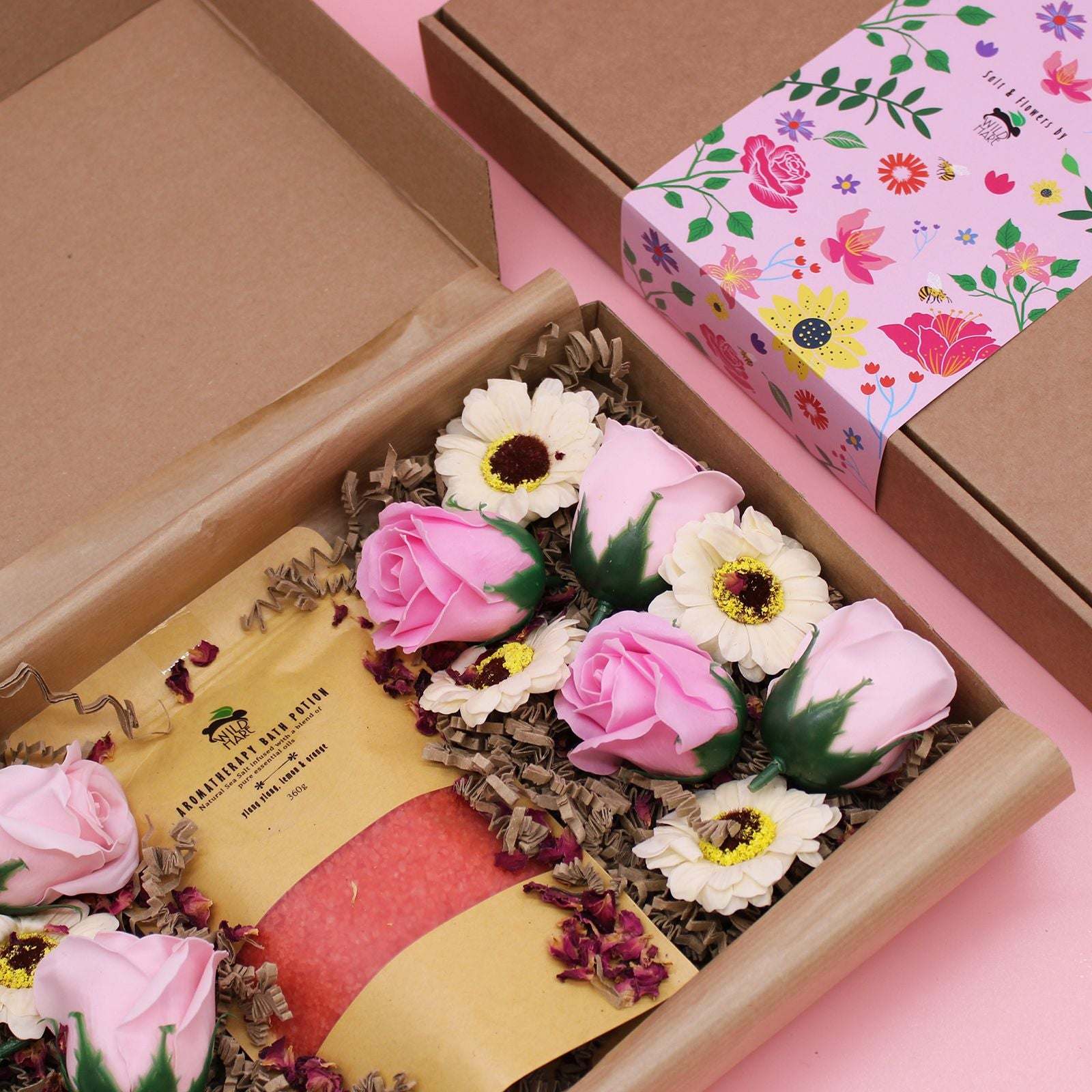 Salt Soak Set with natural bath salts, pink roses, and white flowers in elegant floral packaging