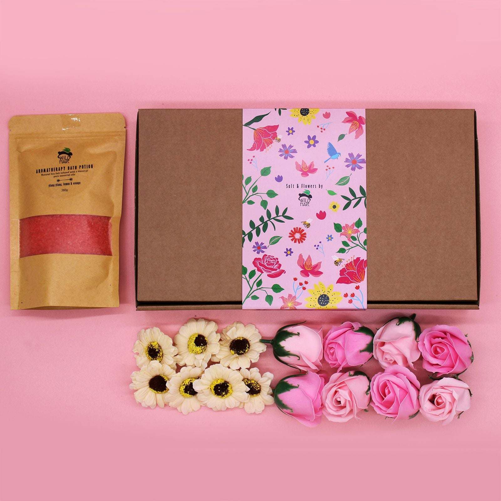 Salt Soak Set packaging with aromatic salt pouch and decorative flowers on pink background