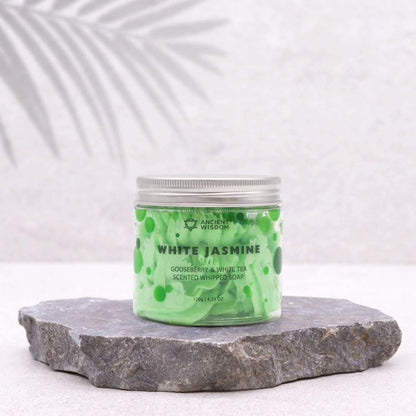 Gooseberry & White Tea scented white jasmine whipped soap in a green jar on stone slab