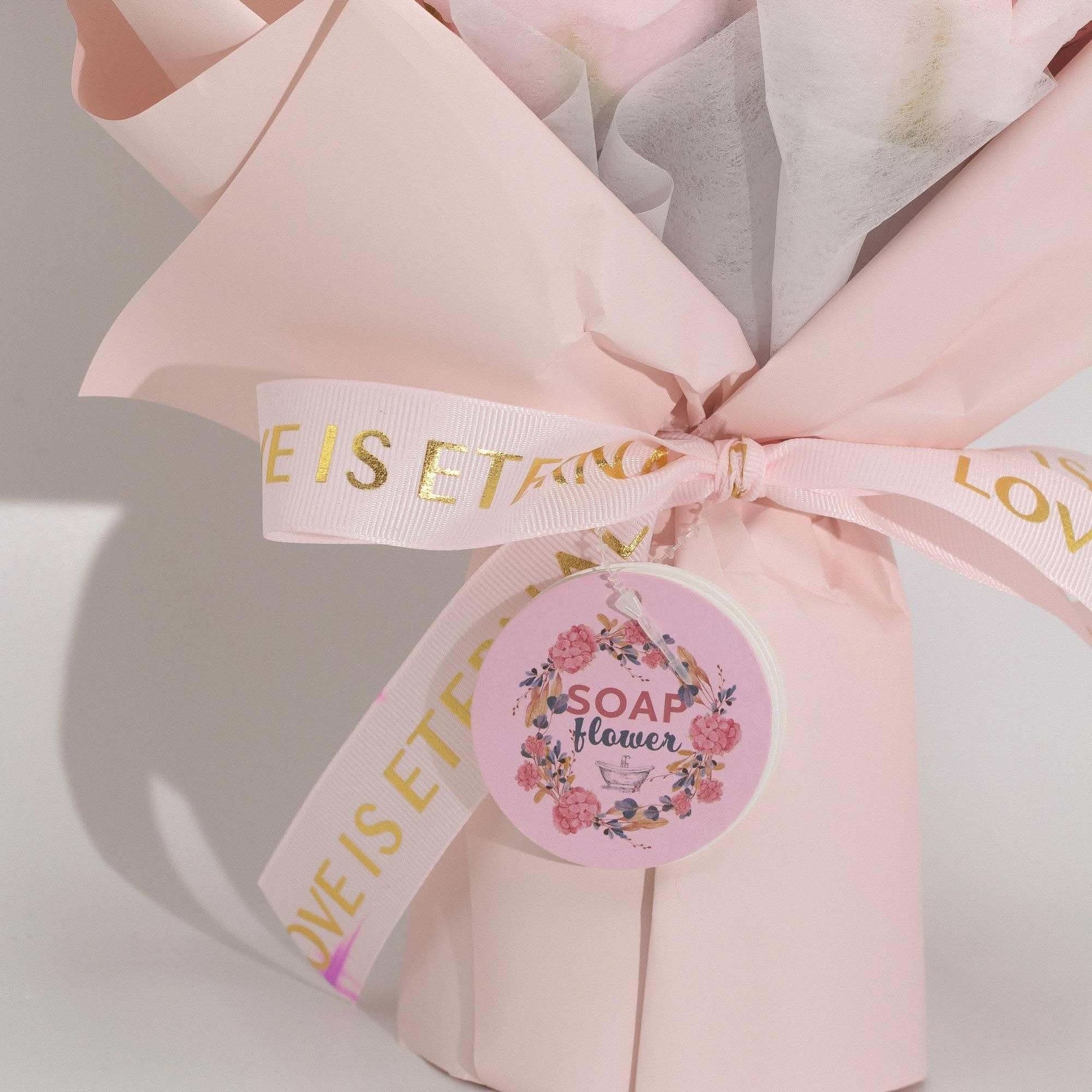Large pink roses bouquet of soap flowers wrapped with love is eternal ribbon and gift card