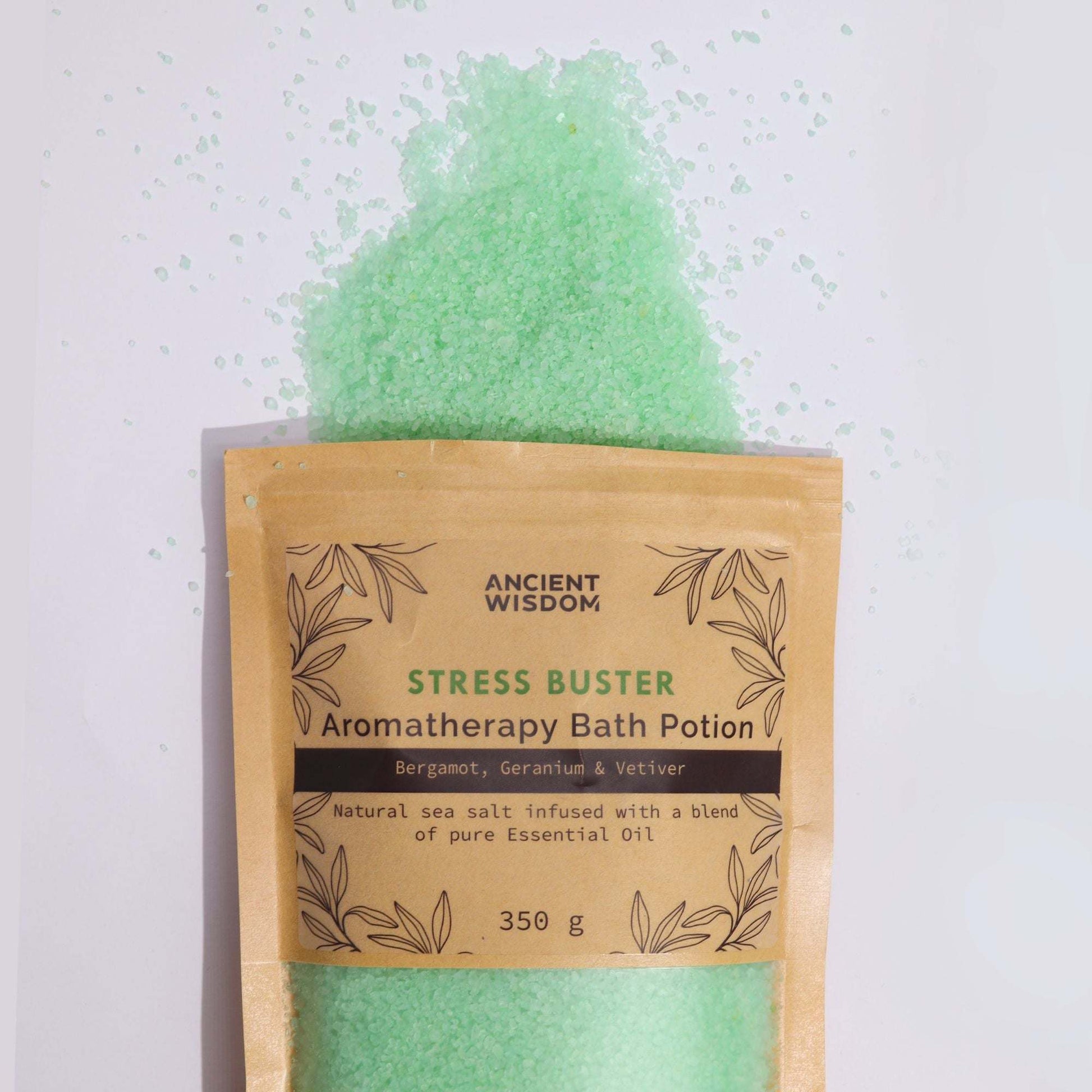 Aromatherapy Bath Potion Stress Buster with Bergamot, Geranium, and Vetiver in kraft bag with green bath salt spilling out