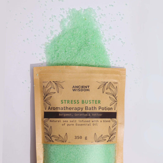 Aromatherapy Bath Potion Stress Buster with Bergamot, Geranium, and Vetiver in kraft bag with green bath salt spilling out