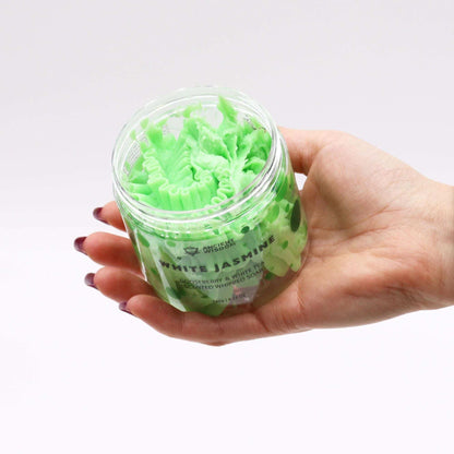 Gooseberry and white tea whipped soap in green jar held in hand, creamy texture with moisturizing properties, cruelty-free and vegan-friendly