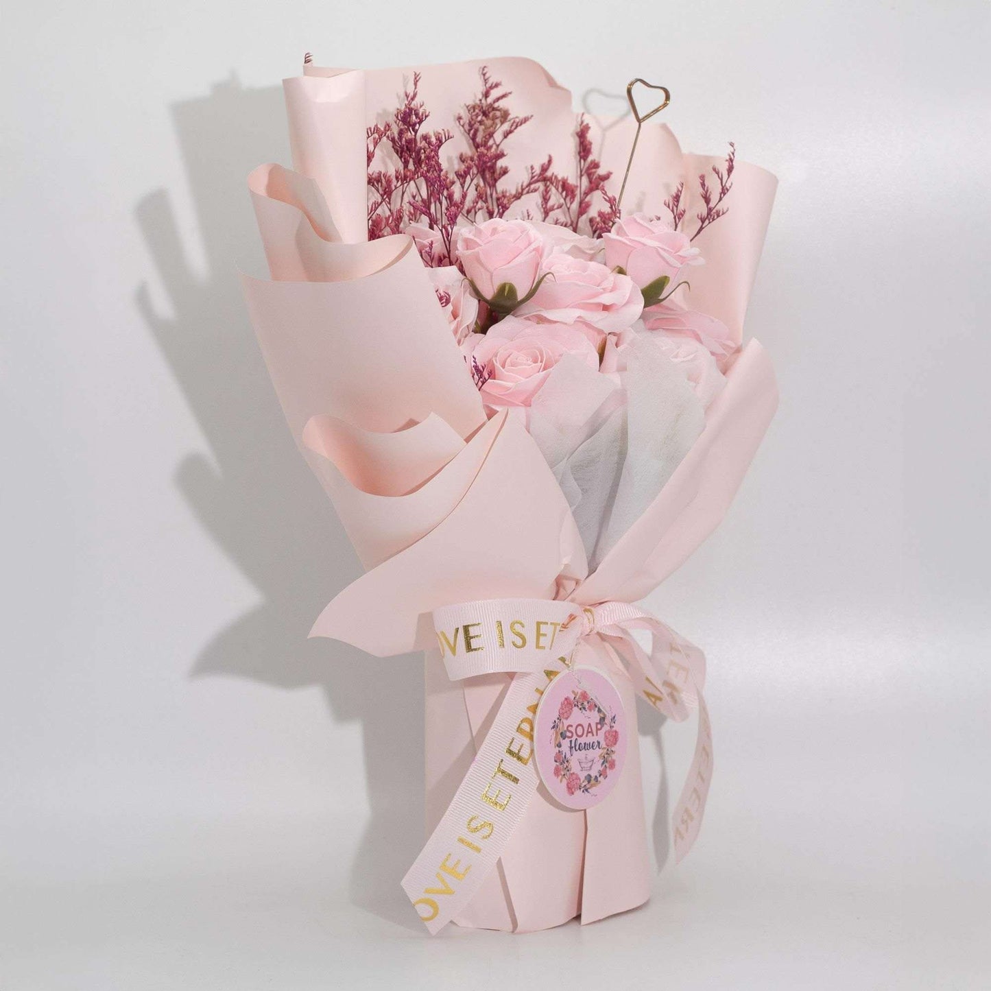 Large pink roses bouquet of soap flowers wrapped in pink paper with satin ribbon and gift card