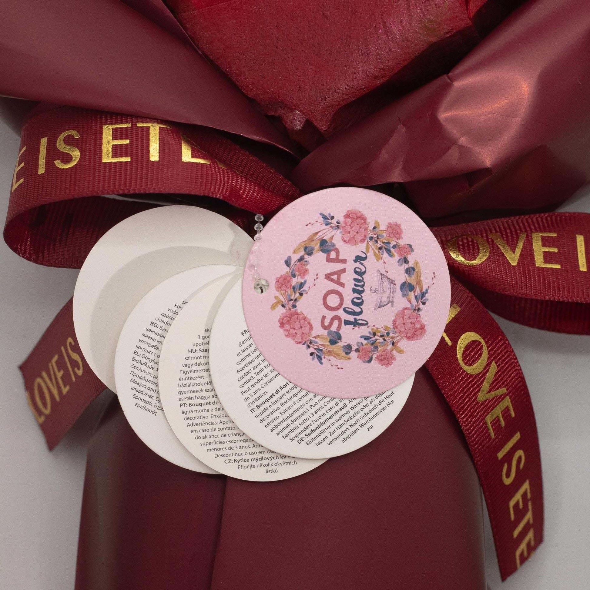 Large red roses bouquet of soap roses wrapped in wine paper with satin ribbon and gift card