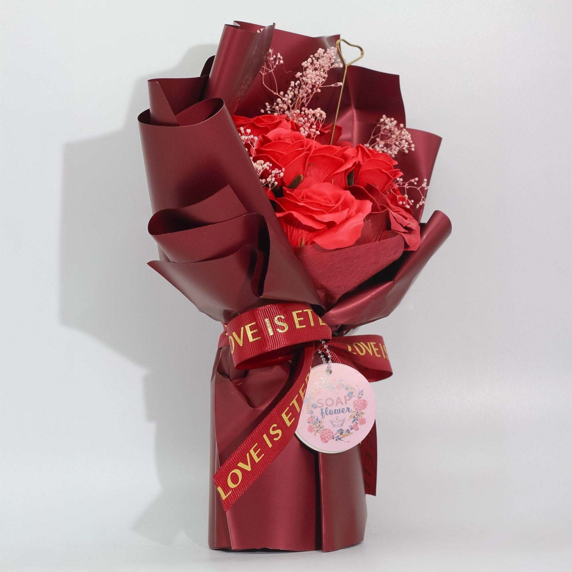 Large red soap roses bouquet wrapped in wine paper with Love is Eternal ribbon and gift card