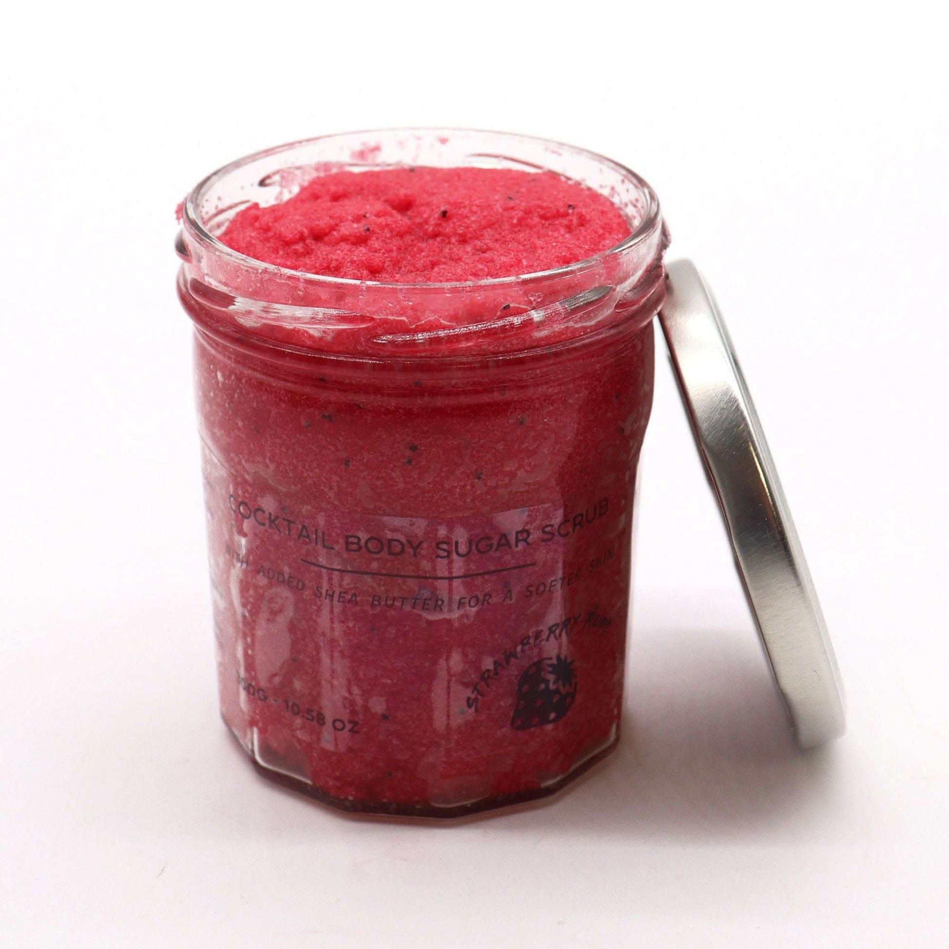 Strawberry rum fragranced sugar body scrub in open glass jar 300g