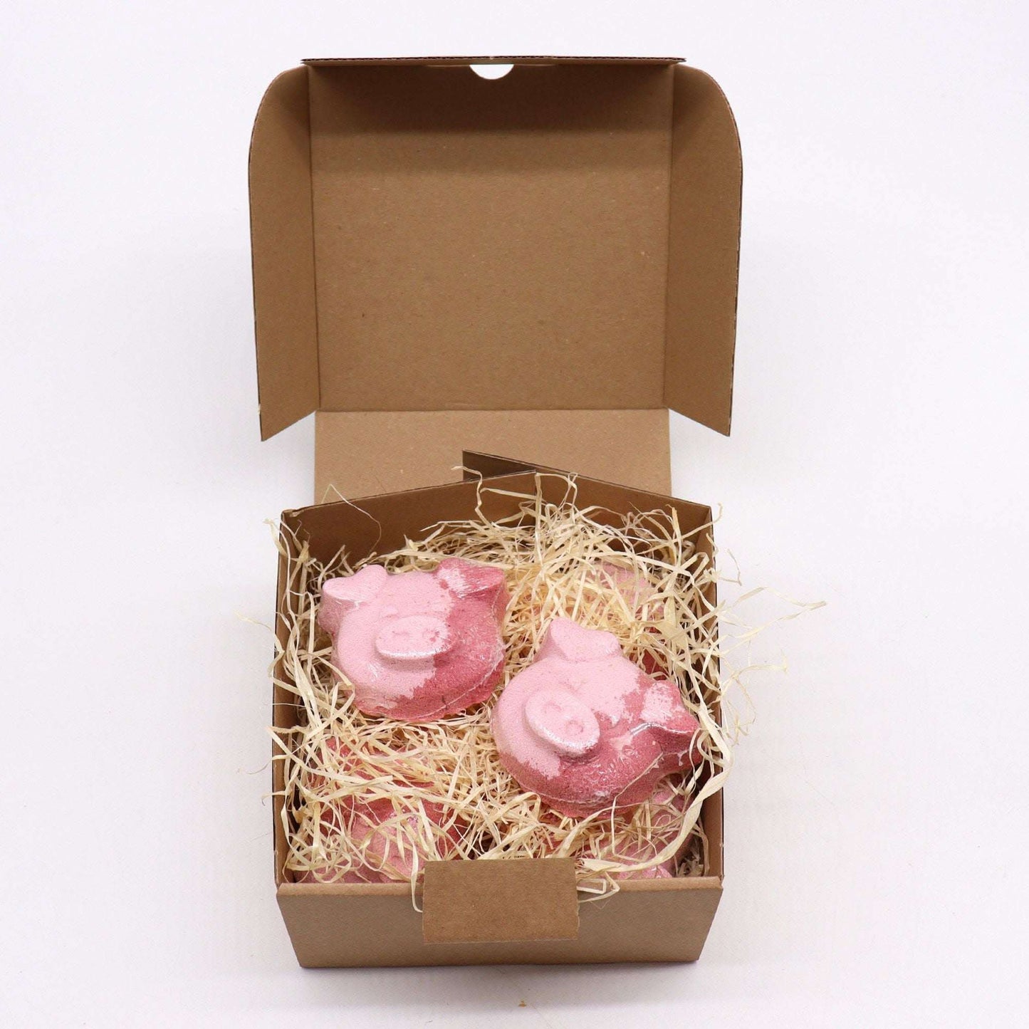 Pig bath bombs with vanilla cupcake scent in a cardboard gift box