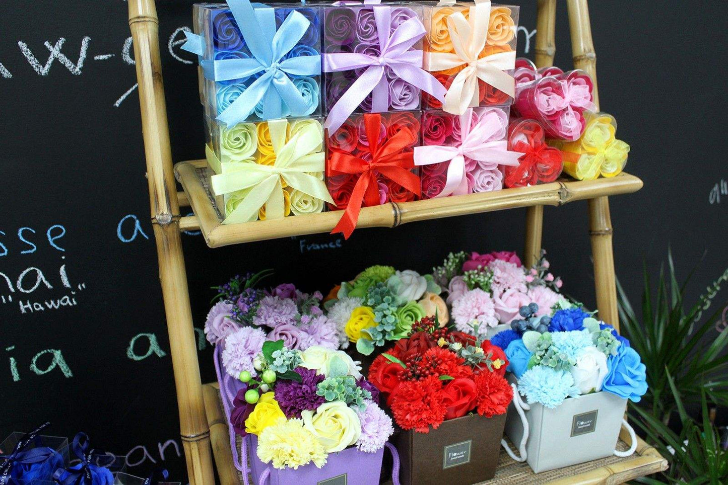 Colorful set of 9 soap flower box roses gift boxes and bouquets displayed on bamboo shelf